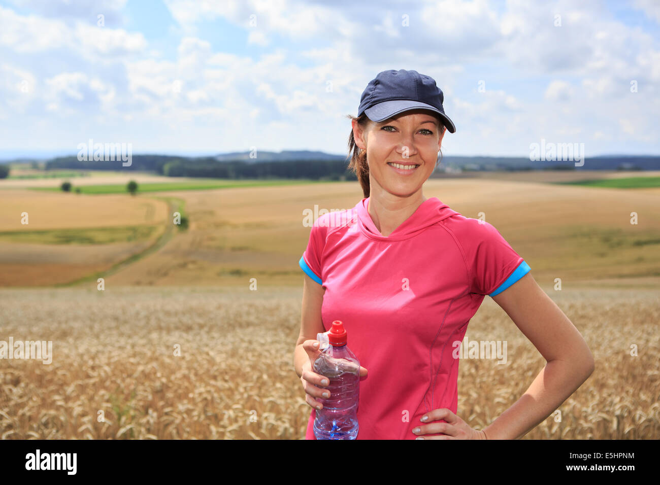 a woman running through the rural landscape Stock Photo