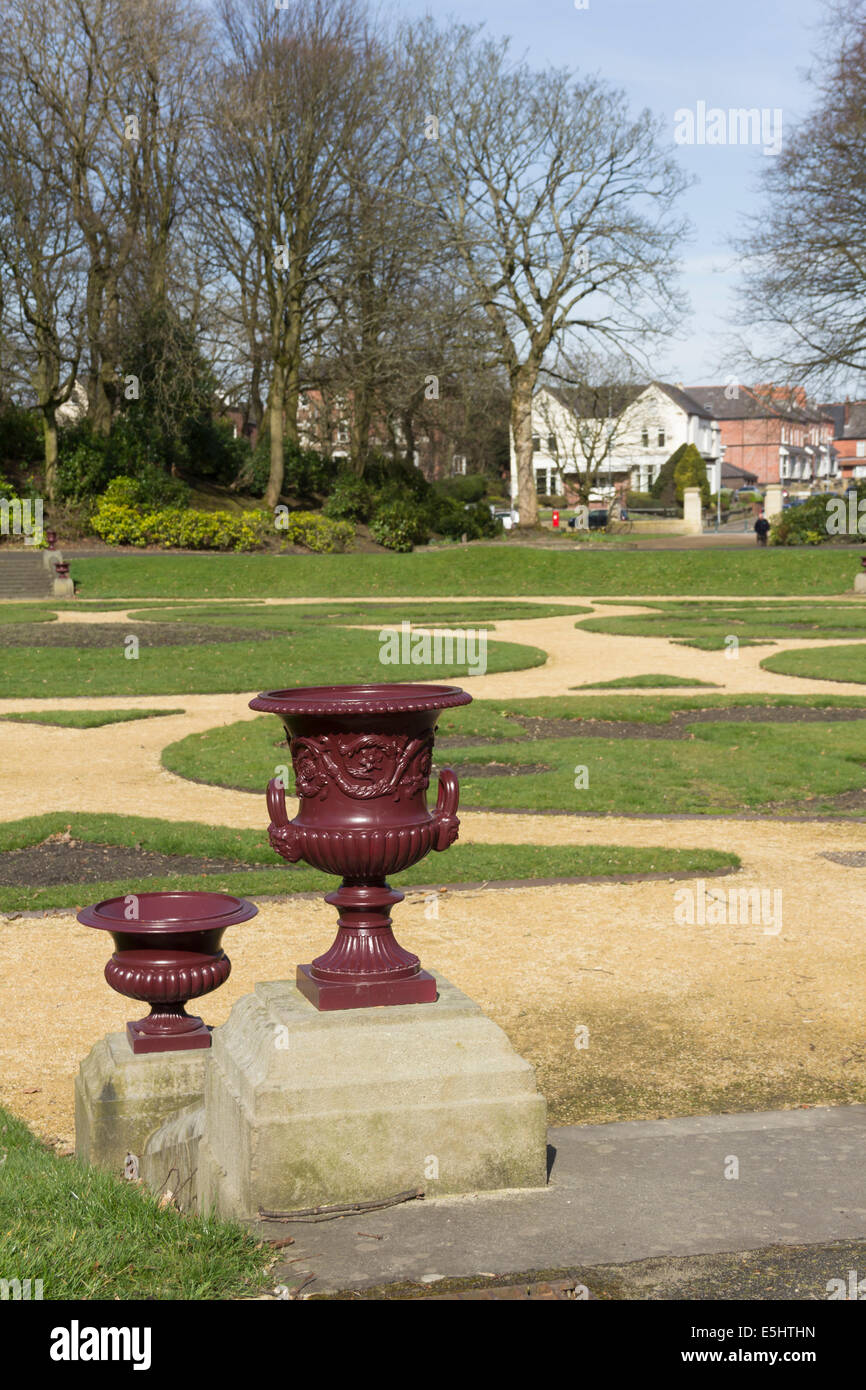 Decorative urns line the steps which lead to the restored circular sunken garden, part of Queens Park Bolton. Stock Photo