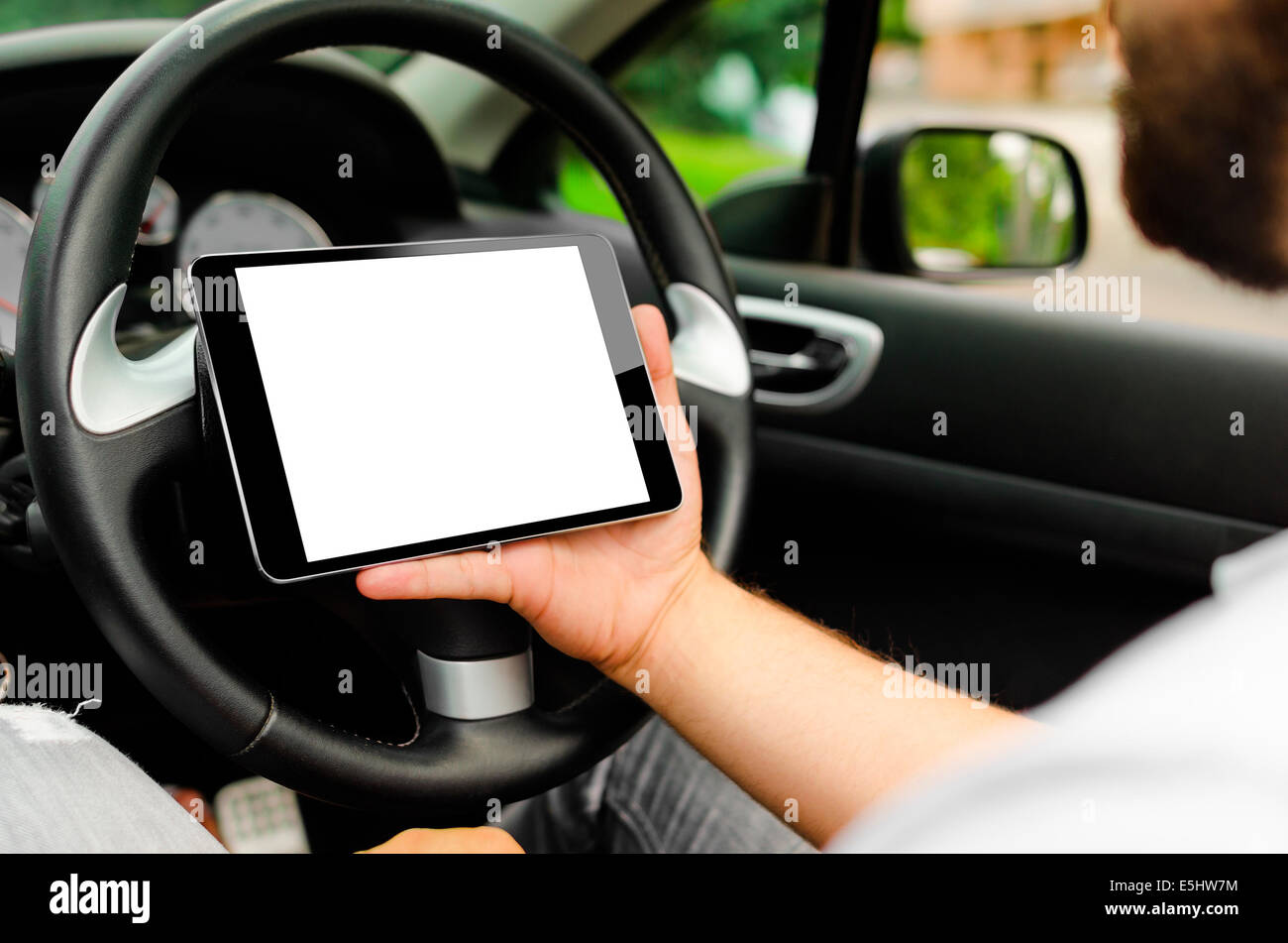 The man in the car, with the Tablet PC in hands Stock Photo