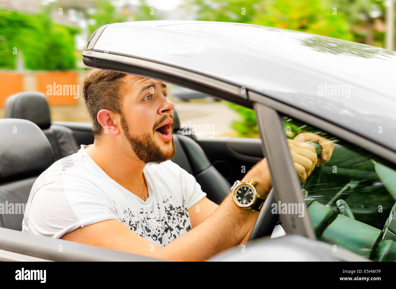 Fright face of man driving car and strongly hold the wheel Stock Photo