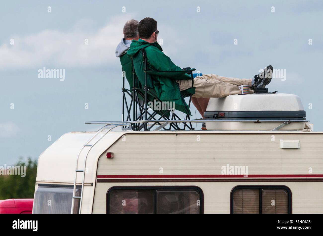 2-men-sitting-relaxing-on-top-of-a-motor