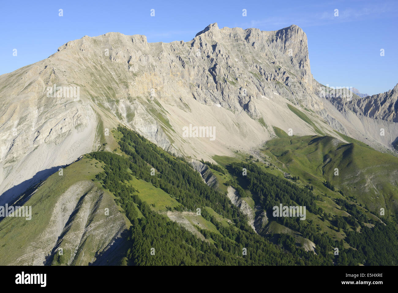 AERIAL VIEW. 600-meter-high eastern limestone cliff of Pic de Bure (elevation: 2703 meters). Massif du Dévoluy, Hautes-Alpes, France. Stock Photo