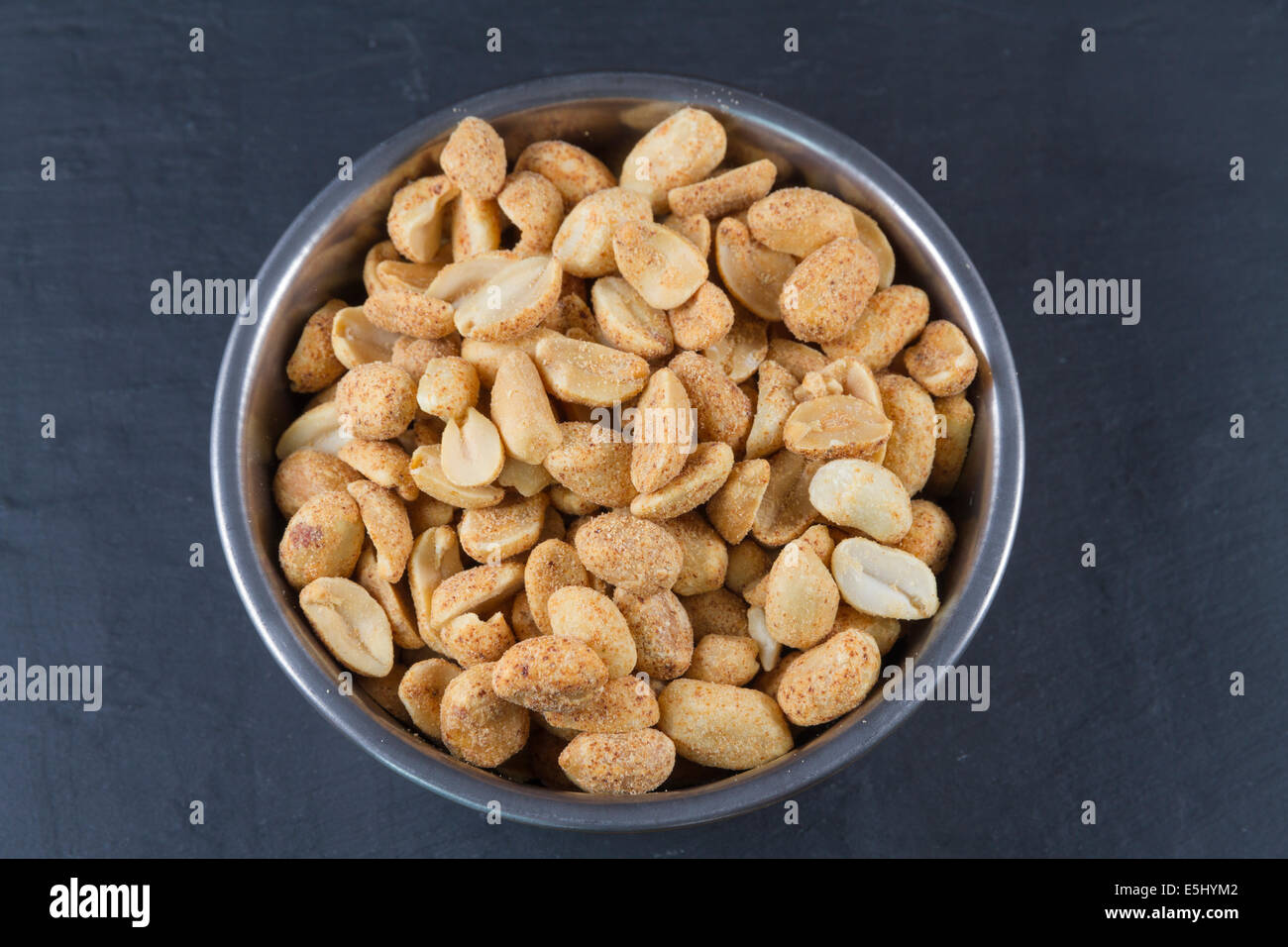 Bowl of dry roast peanuts on slate mat Stock Photo Alamy