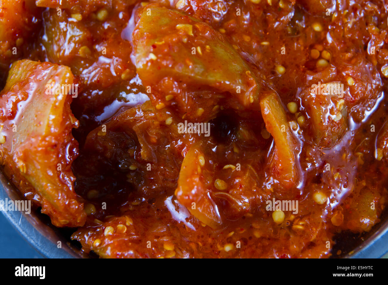 Close up of Indian chutney lime pickle in metal bowl. Accompaniment for poppadoms. Stock Photo