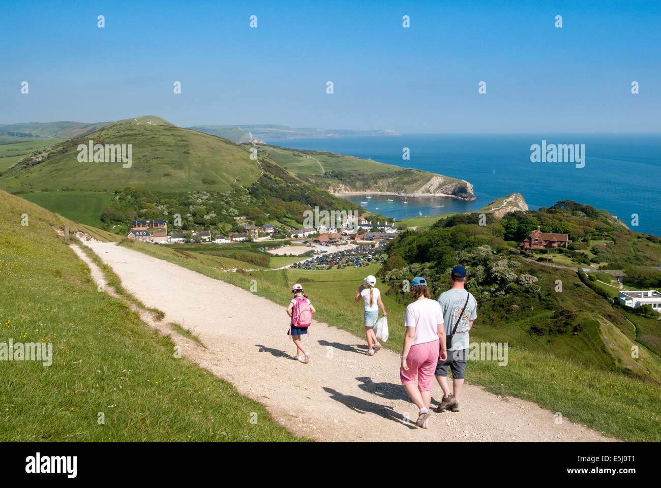 Family walking along coast to Lulworth Cove, Jurassic Coast, Dorset, England, UK Stock Photo