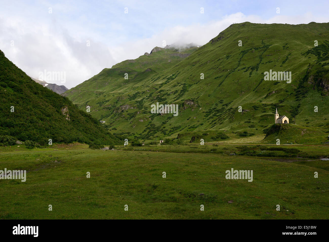 Isolated church in a grassy valley. Riale, Val Formazza, Province of Verbano-Cusio-Ossola, Piedmont, Italy. Stock Photo