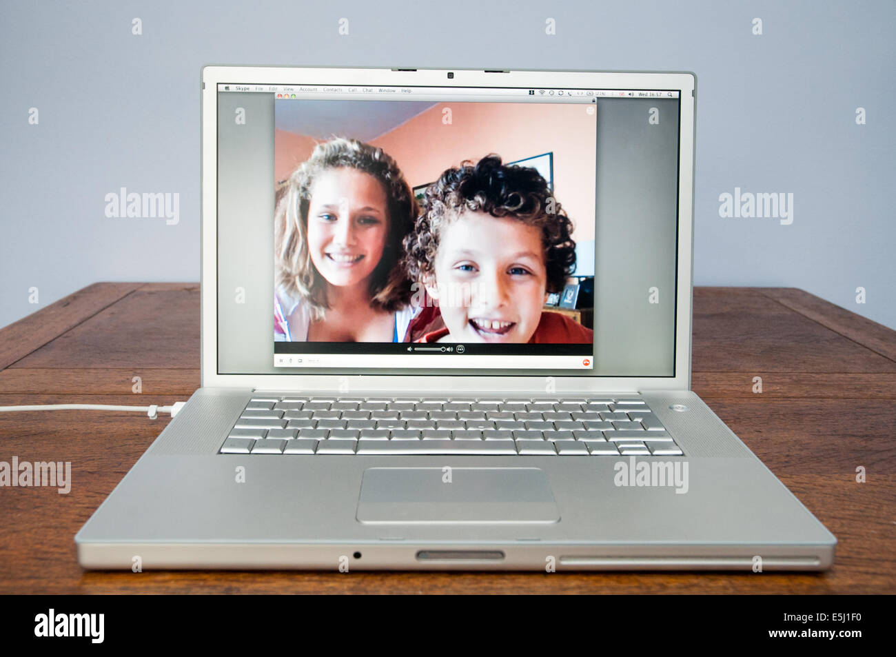 Children talking on Skype on Apple laptop computer, England, UK Stock Photo