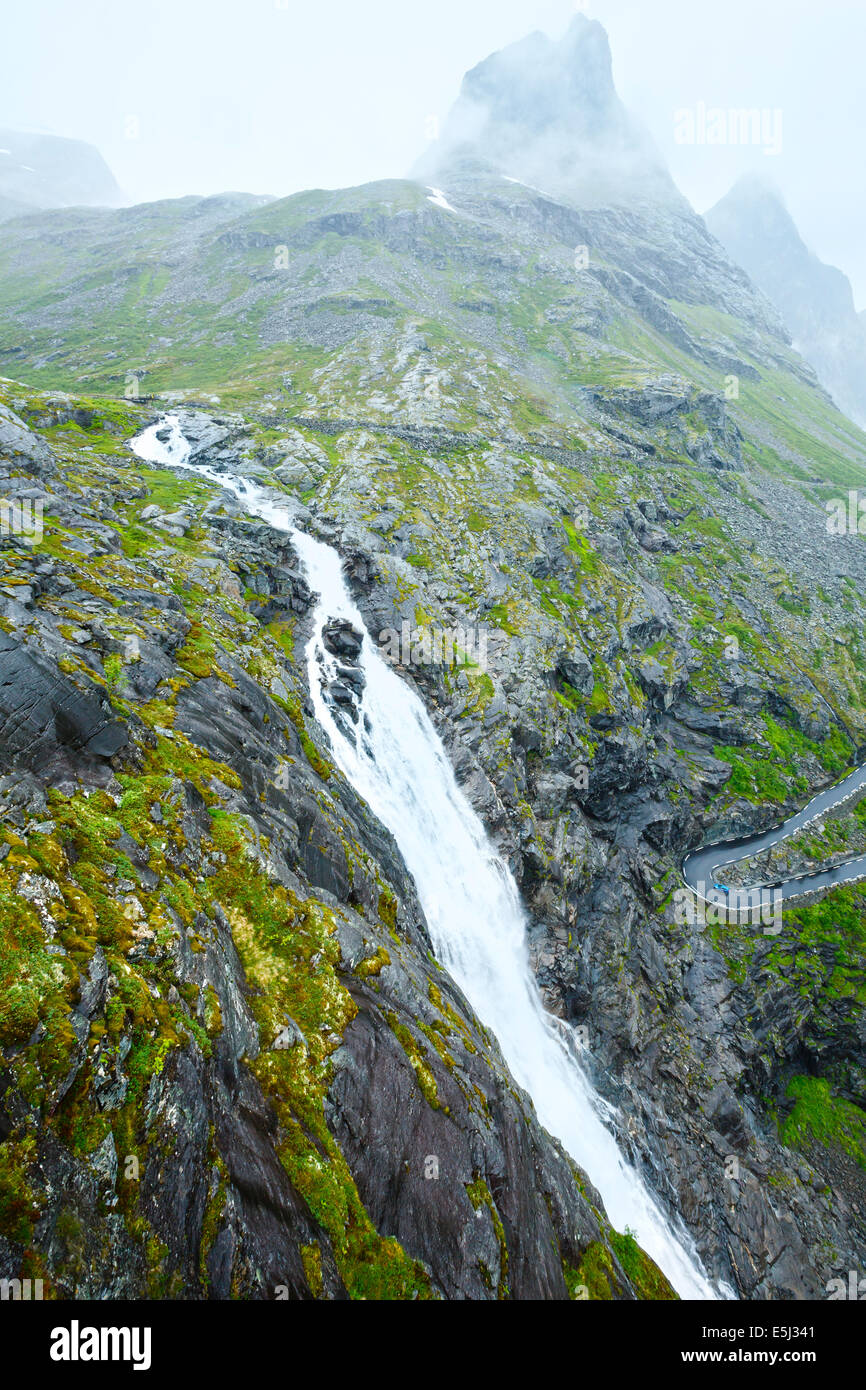 Summer mountain  cloudy view with waterfall on slope (Norway). Stock Photo