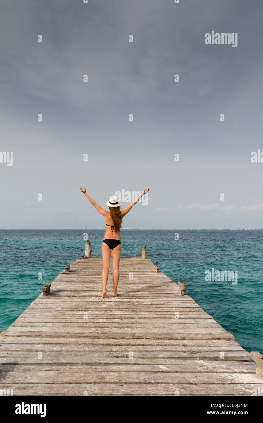 Young woman standing at the pier with a black bikini Stock Photo