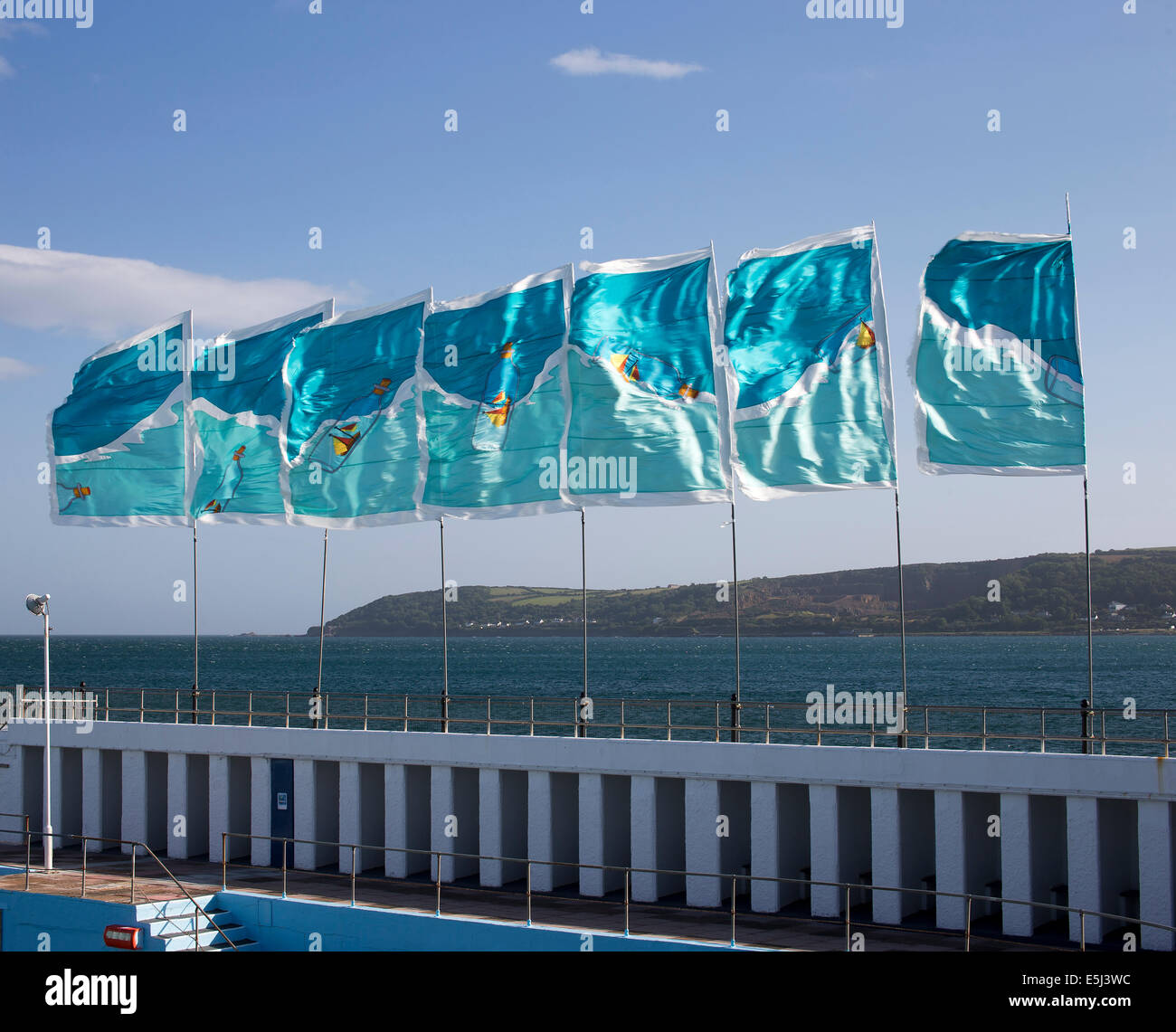 Flags flying over the Jubilee Pool, Penzance, Cornwall, UK, an Art Deco lido to celebrate King George V's Jubilee in 1935. Stock Photo