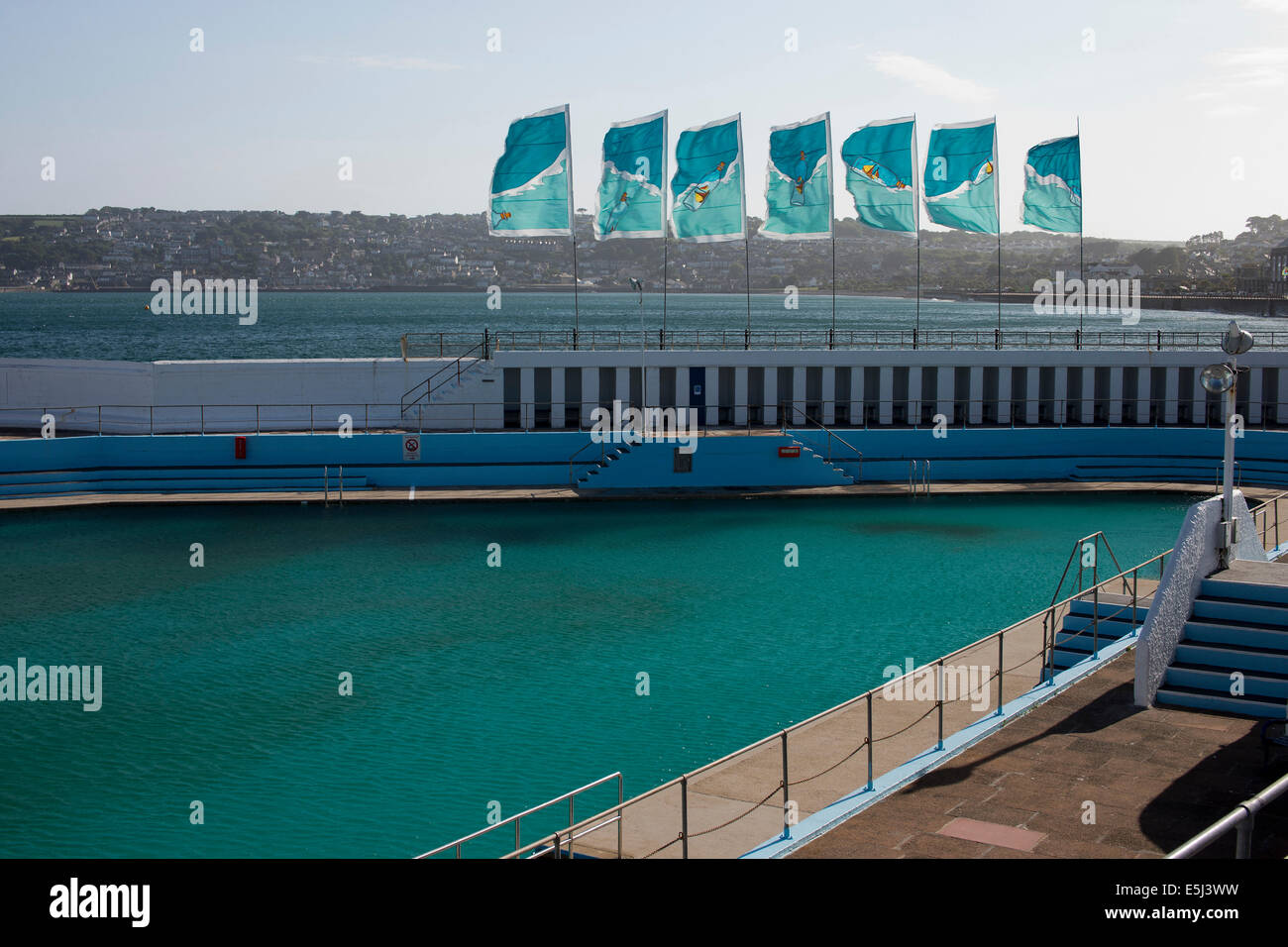 Flags flying over the Jubilee Pool, Penzance, Cornwall, UK, an Art Deco lido to celebrate King George V's Jubilee in 1935. Stock Photo