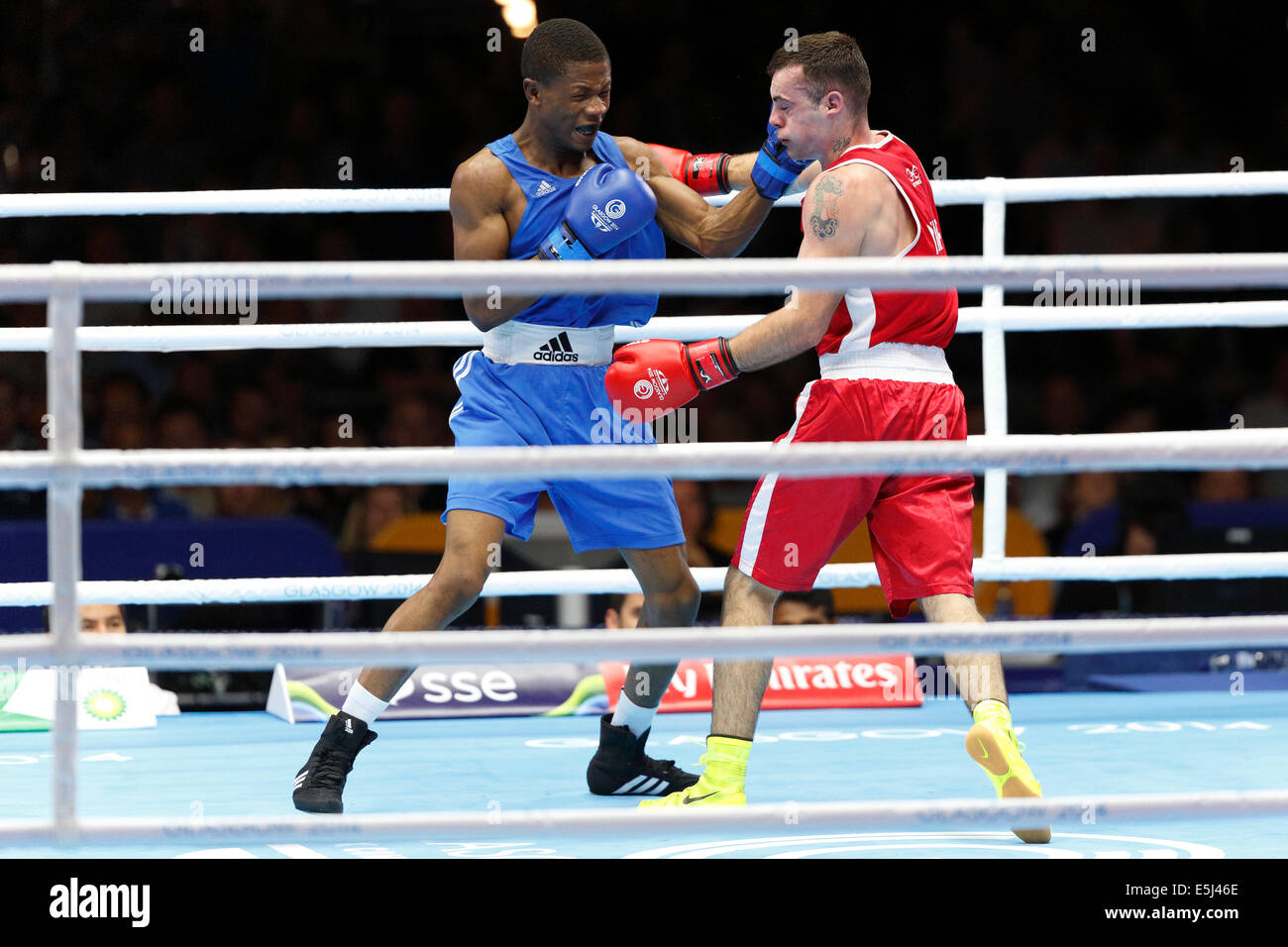 SECC Precinct, Glasgow, Scotland, UK, Friday, 1st August, 2014. Glasgow 2014 Commonwealth Games, Men’s Light Welter Weight 64kg Semi Final, Winner Junias Jonas of Namibia in Blue and Sean Duffy of Northern Ireland in Red Stock Photo