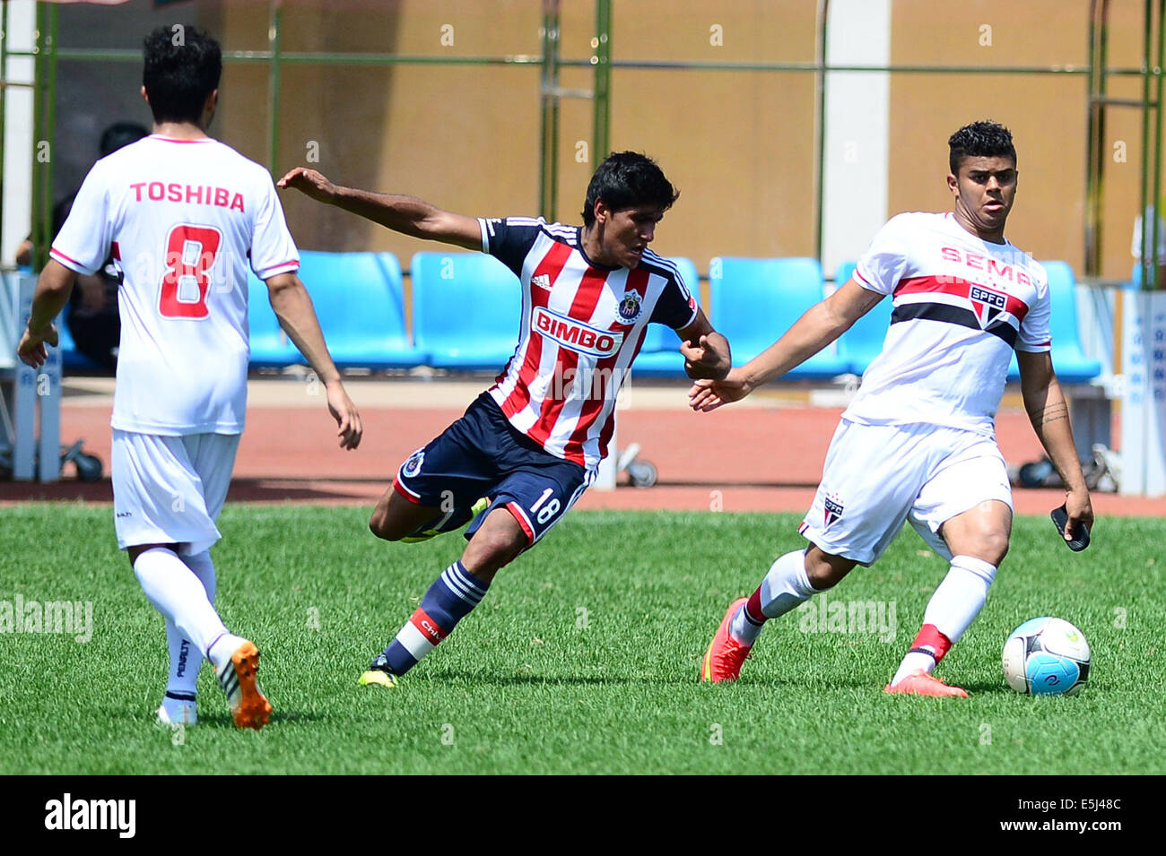 Weifang, China's Shandong Province. 2nd Aug, 2014. Garcia Miguel Angel (C) of Chivas Guadalajara CD vies for the ball during the third-place-final match against Sao Paulo Futebol at the Weifang Cup International Youth Football Tournament in Weifang, east China's Shandong Province, Aug. 2, 2014. Sao Paulo Futebol won 1-0 and won the third place of the event. © Guo Xulei/Xinhua/Alamy Live News Stock Photo