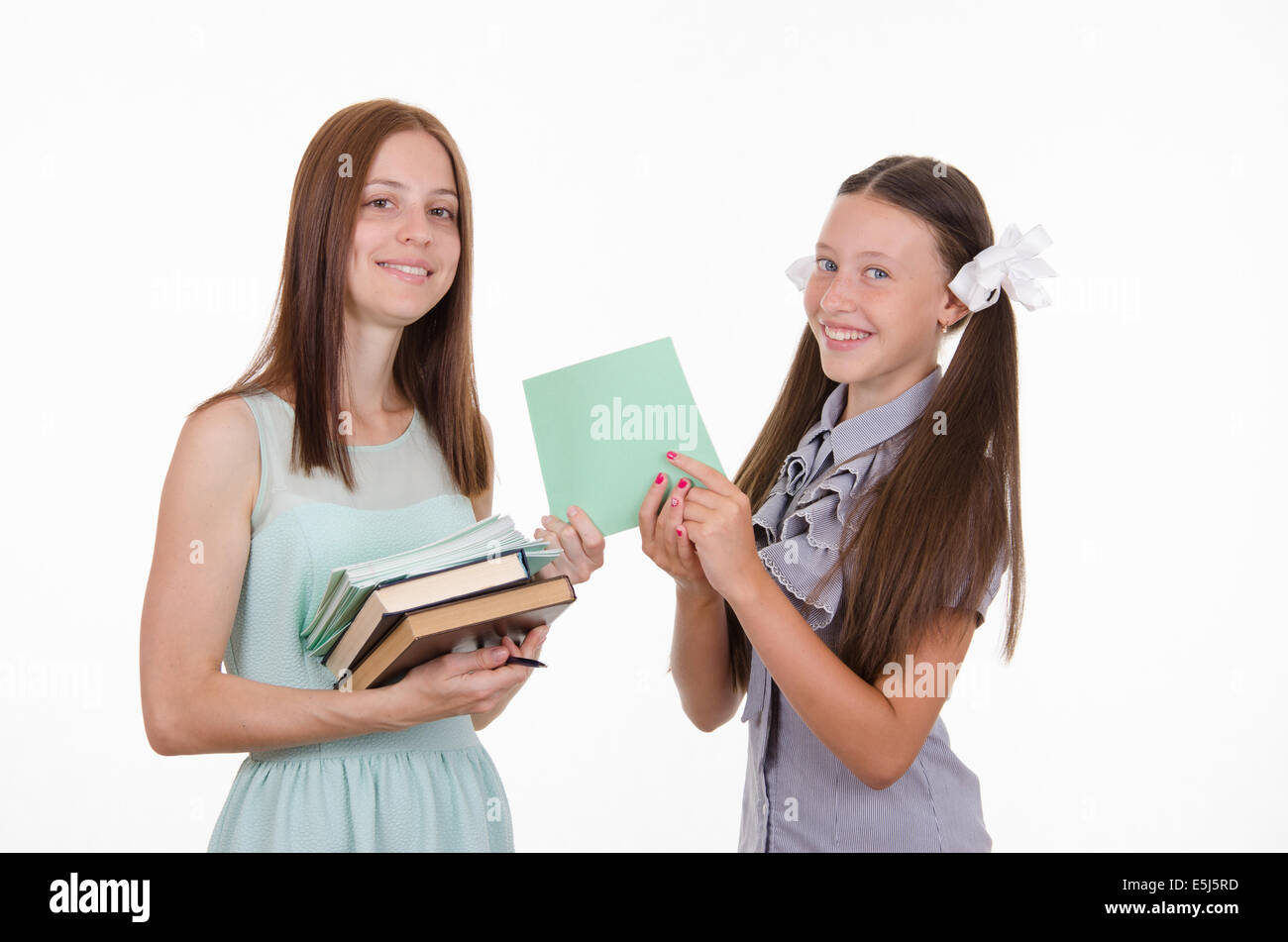 School teacher and student holding a book and notebook Stock Photo