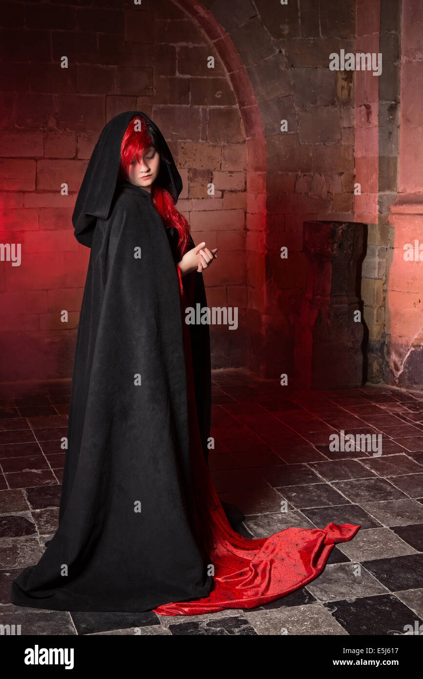 Gothic witch woman standing in a medieval castle Stock Photo