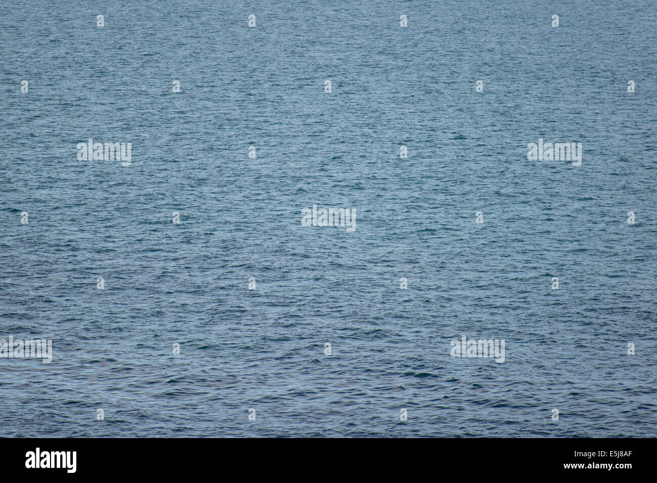 Background of ocean water around Greenland with water surface in light wind Stock Photo