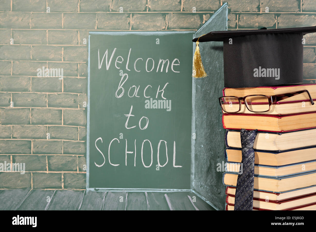 Back to school card with text on chalkboard and professor from books Stock Photo