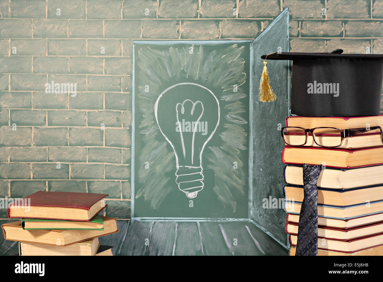 Knowledge concept with illustration of bulb on chalkboard and teacher from books Stock Photo