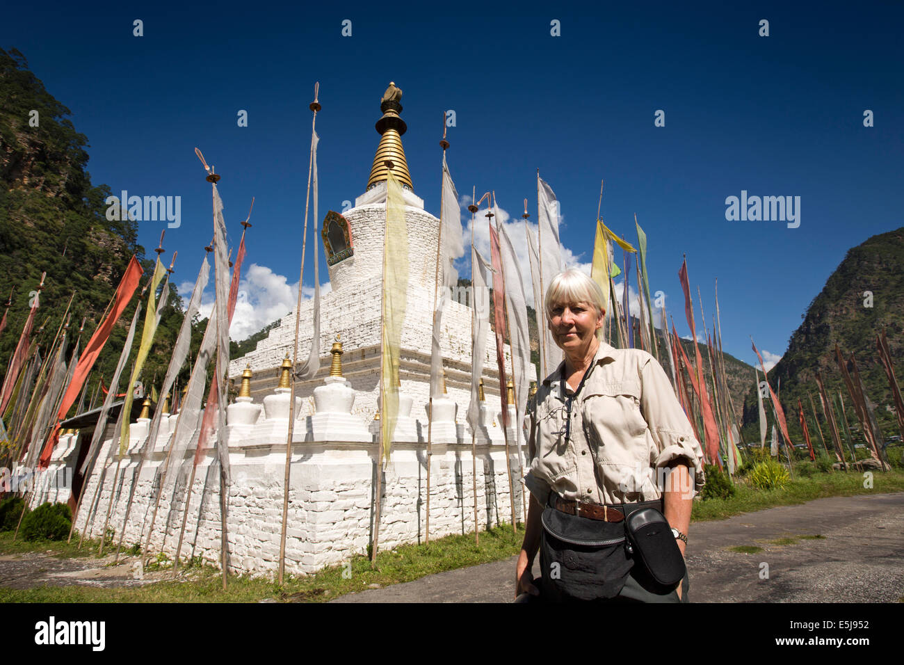 Eastern Bhutan, Lhuentse Valley Autsho, senior western tourist visiting Tibetan style chorten, Stock Photo