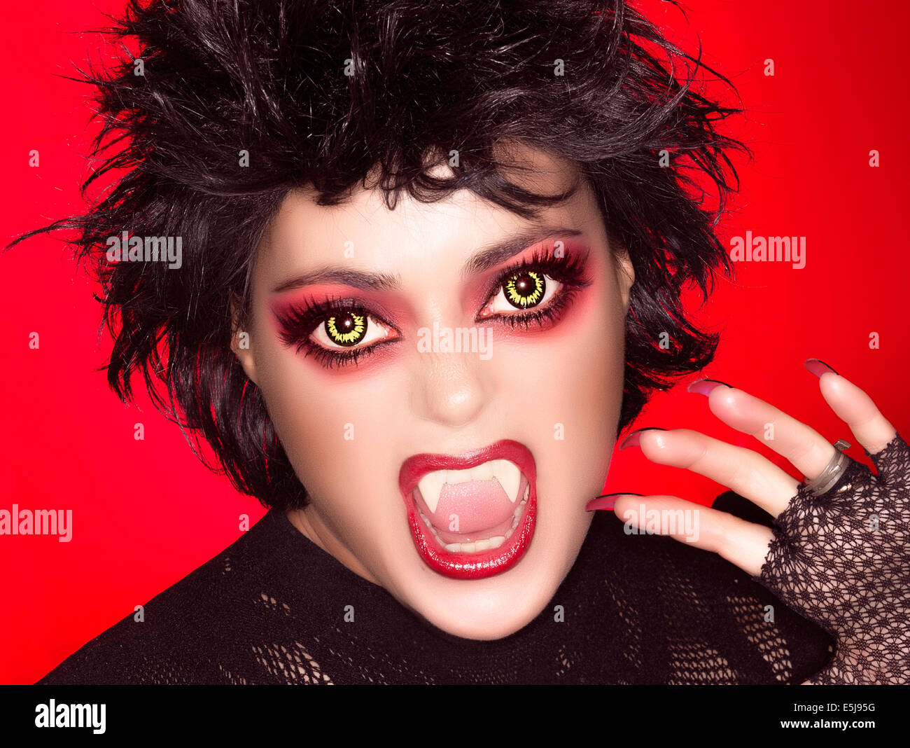 Beautiful caricature of gothic girl screaming with fancy makeup, wolf  lenses and big fangs Stock Photo - Alamy