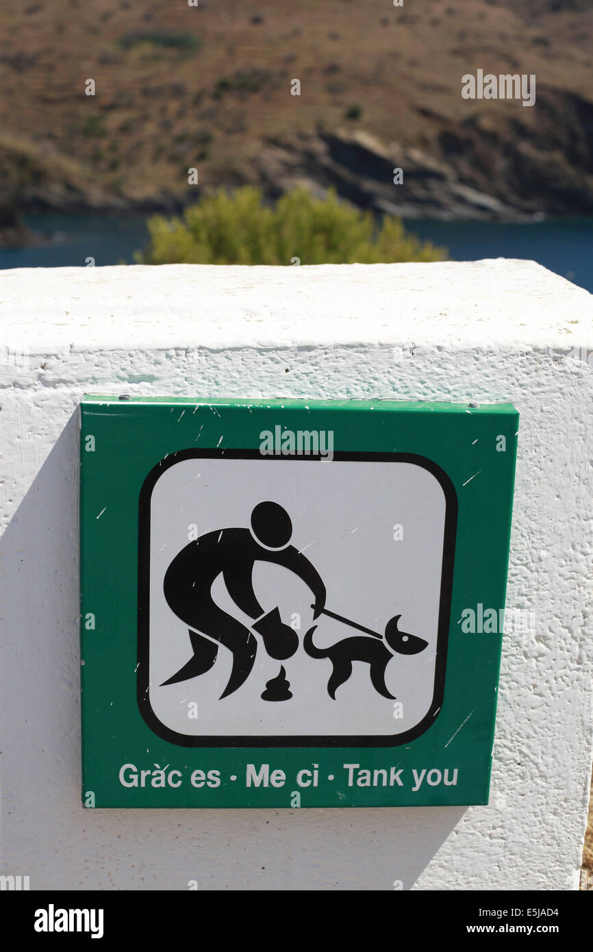 A very artistic Catalan sign encouraging visitors to the Walter Benjamin memorial in Port Bou to clean up after their dogs. Stock Photo