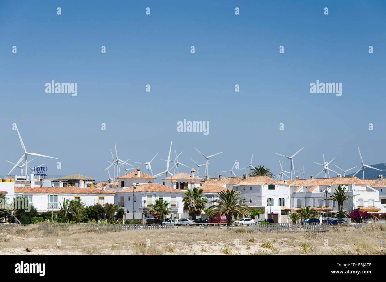 Group of wind turbines behind an urbanisation of Zahara de los atunes. Cadiz, Andalusia, Spain. Stock Photo