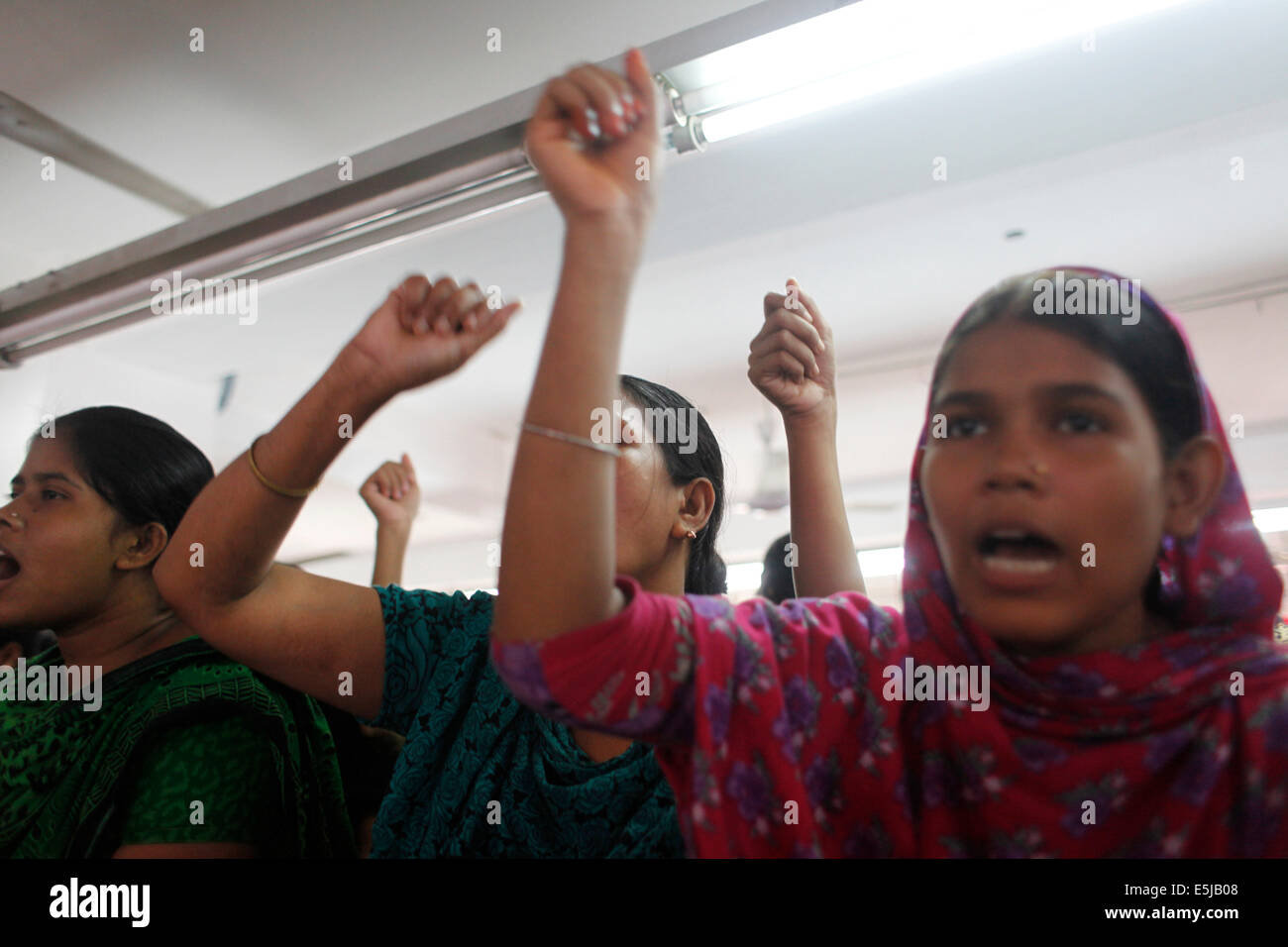 Dhaka, Bangladesh. 2nd Aug, 2014. Several hundreds of workers of Tuba Group continuing their hunger strike for the sixth consecutive day in the factory demanding outstanding salaries and Eid bonus. Over 1, 600 workers of Tuba Group, which also owns Tazreen Fashions Limited that was burnt down in November 2012 killing 112 workers, protested for their salaries and and Eid bonuses during the months of May, June and July. Credit:  zakir hossain chowdhury zakir/Alamy Live News Stock Photo