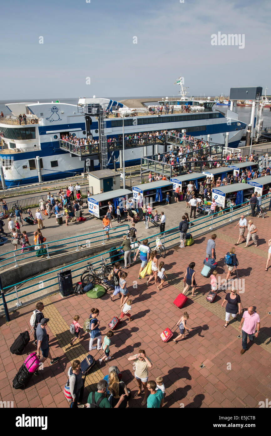 Netherlands, Harlingen, Harbor. People getting off the ferry boat, coming from the island of Terschelling Stock Photo