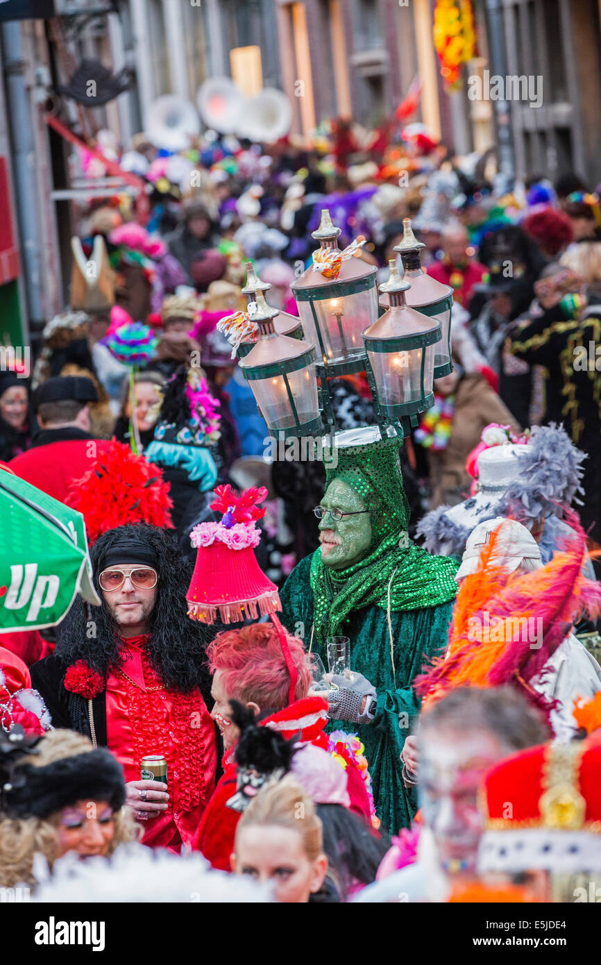 Netherlands, Maastricht, Carnival festival. Costumed man disguised with street lamp on his head Stock Photo
