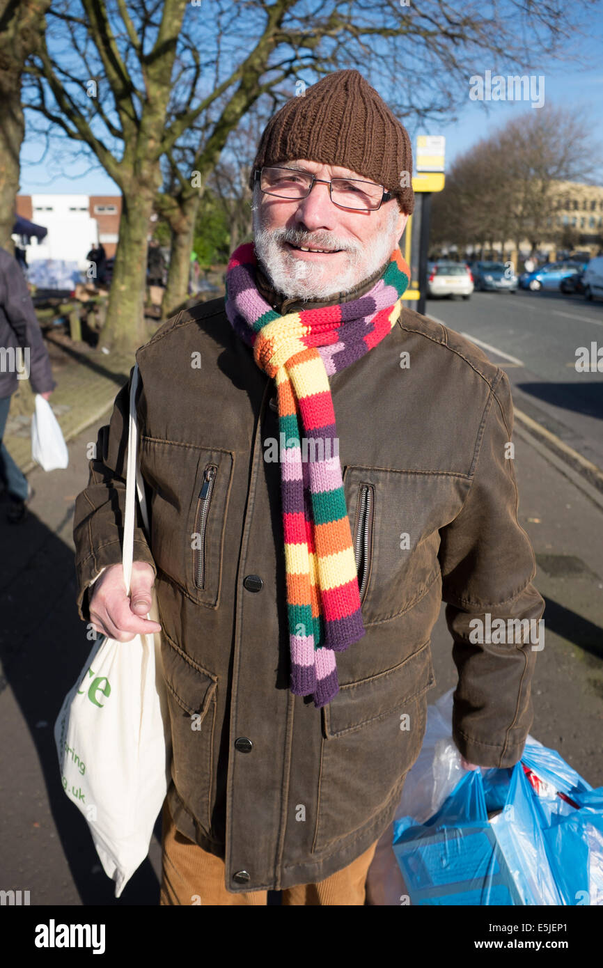 Shopper with brightly coloured rainbow winter scarf Stock Photo