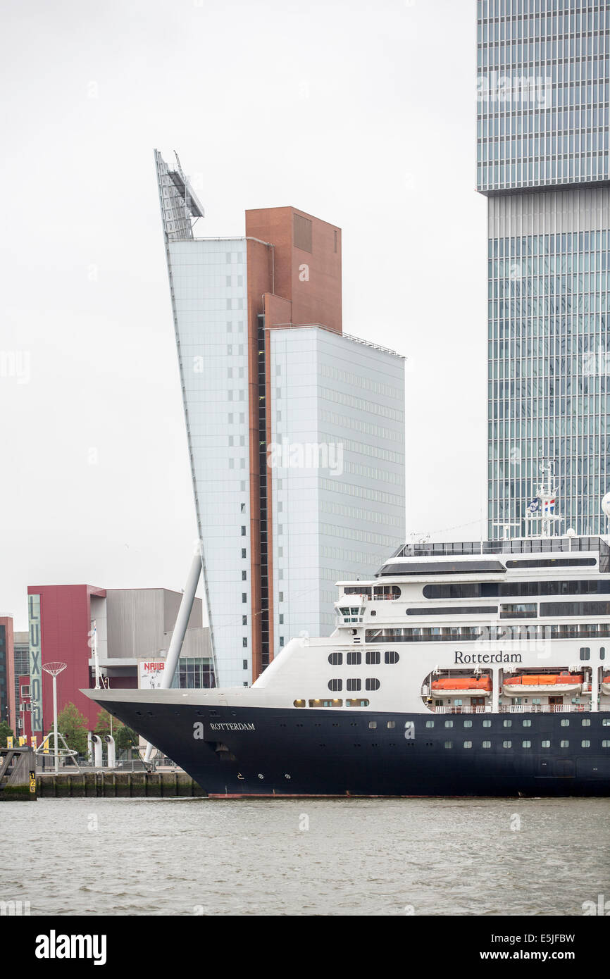 Netherlands, Rotterdam, Kop van Zuid District with cruise terminal and highrise buildings. Cruise ship MS Rotterdam moored Stock Photo