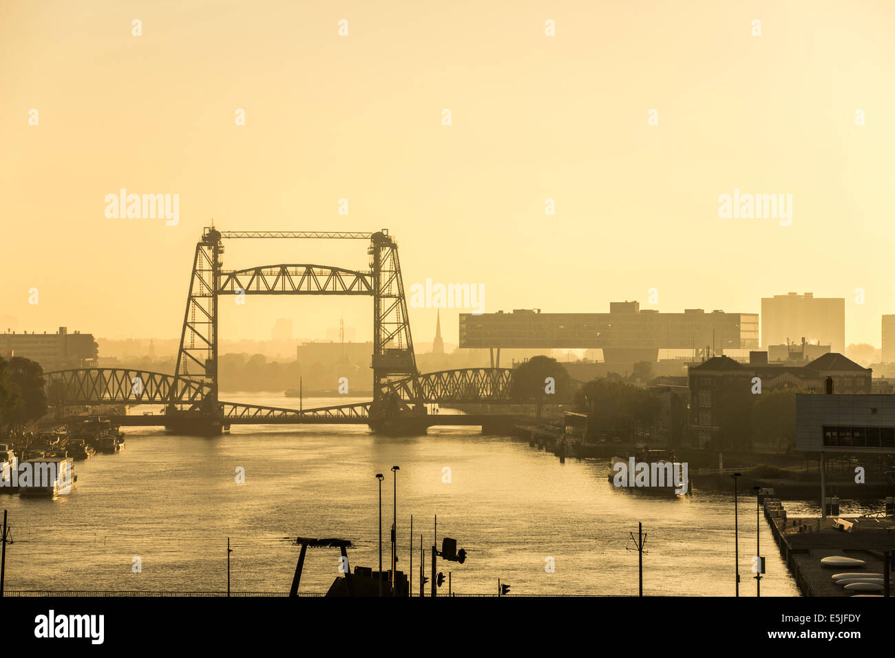 Netherlands, Rotterdam, Bridge called De Hef. Right Unilever Netherlands Headquarters. Sunrise. Cruise ship MS Rotterdam Stock Photo