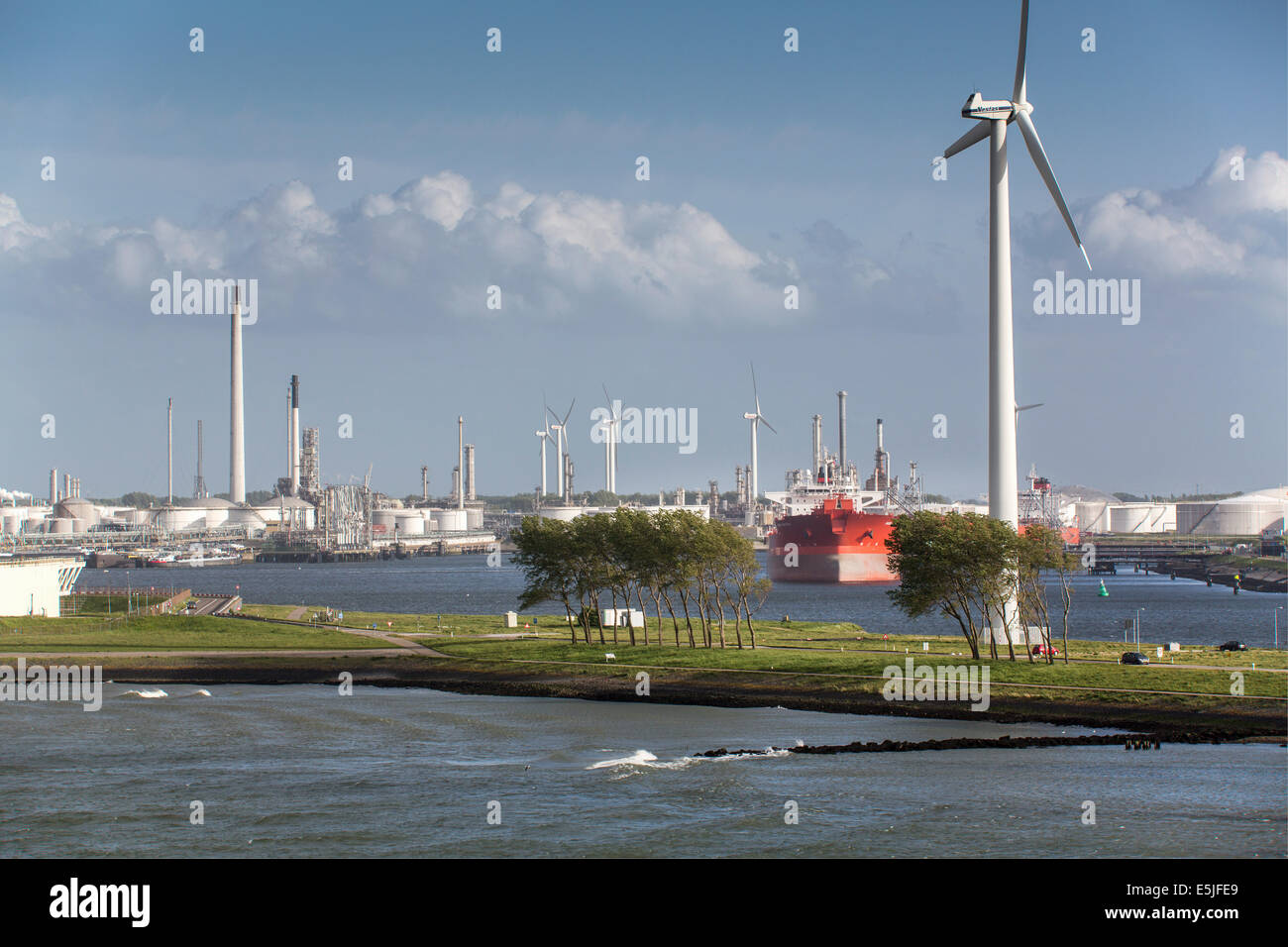 Netherlands, Rotterdam, Port of Rotterdam. Harbour or harbor. Oil storage and petro chemical industries. Wind turbines Stock Photo