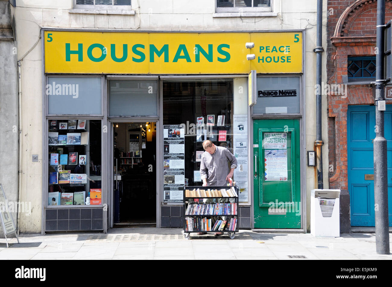 Man looking through books outside Housmans Bookshop and Peace Store, Caledonian Road, Kings Cross,Islington London England UK Stock Photo