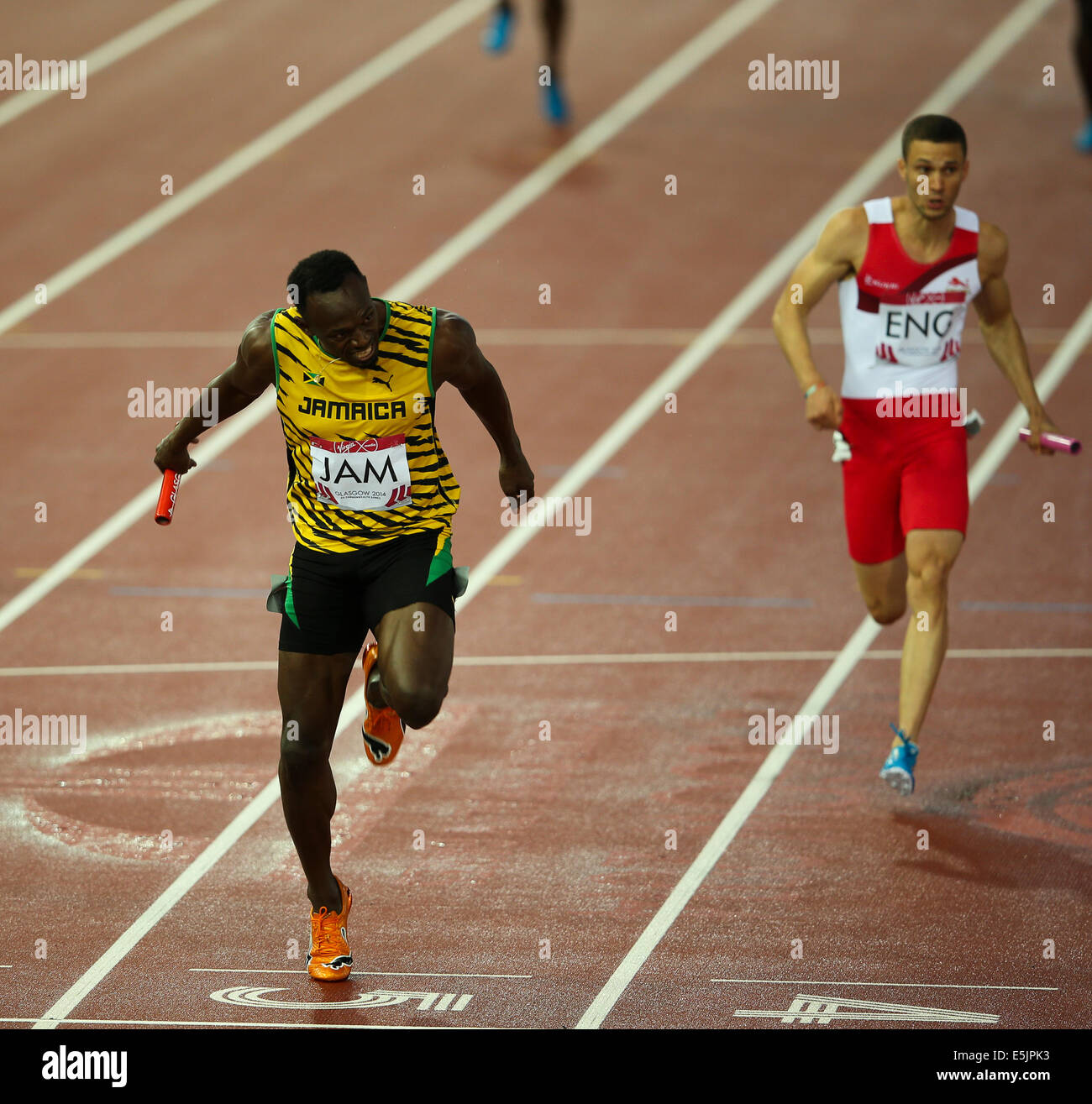 Hampden Park Glasgow 2 August 2014. Commonwealth Games Men's 4x100 final.  Usain Bolt brings home the baton for Jamaica in a new Games record time of 37.58.  England finished second in 38.02. Jamaican team - Jason Livermore; Kemar Bailey-Cole; Nickel Ashmeade and Usain Bolt. Danny Talbot ENG follows behind in second Stock Photo