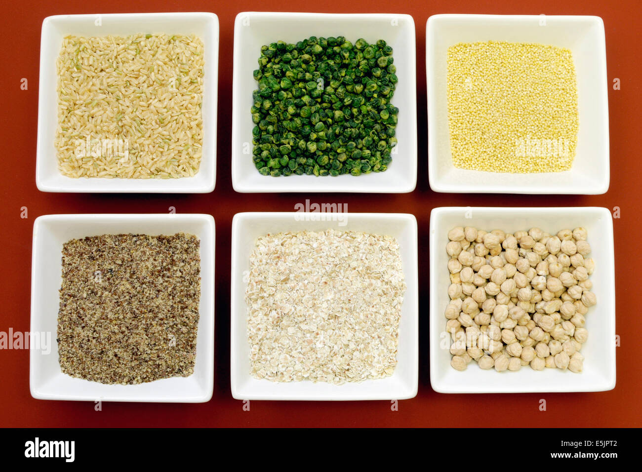Gluten free grains food - brown rice, millet, LSA, buckwheat flakes and chickpeas and green peas legumes - for a healthy diet. Stock Photo