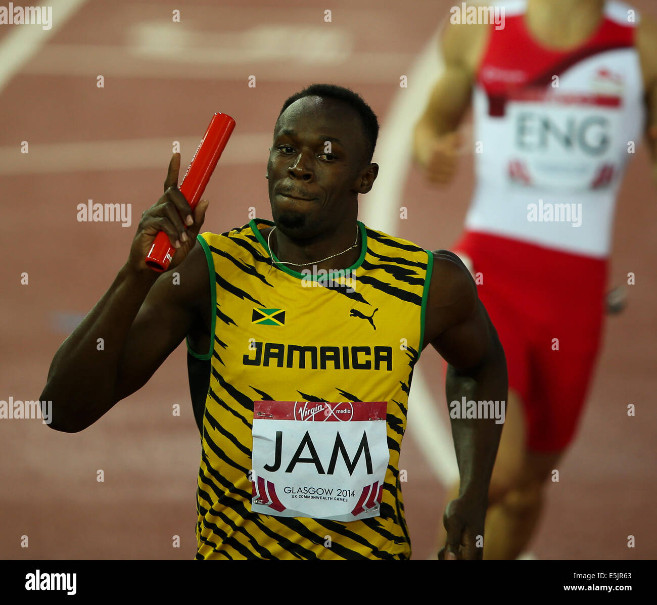 Hampden Park Glasgow 2 August 2014. Commonwealth Games Men's 4x100 final.  Usain Bolt brings home the baton for Jamaica in a new Games record time of 37.58.  England finished second in 38.02. Jamaican team - Jason Livermore; Kemar Bailey-Cole; Nickel Ashmeade and Usain Bolt. Danny Talbot ENG follows behind in second Stock Photo