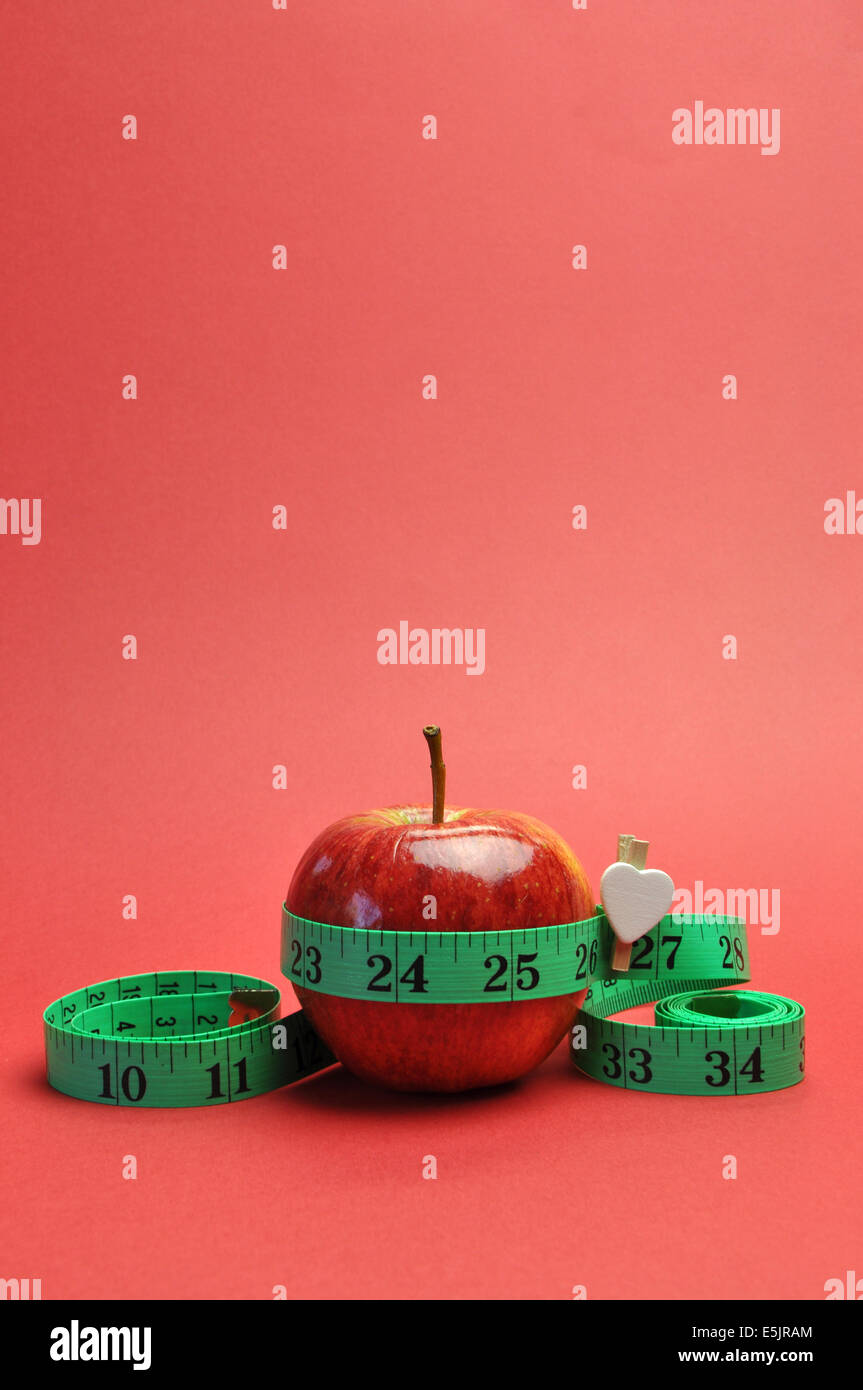 Weight loss slimming diet concept, New Year Resolution, with green measuring tape around a