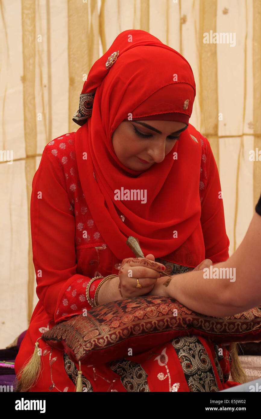 London, UK 2 August 2014. A woman doing henna painting at the Henna Lounge and Studio stall. Credit: David Mbiyu/ Alamy Live News Stock Photo