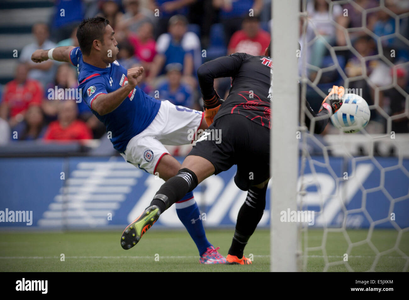 Mexico City, Mexico. 2nd Aug, 2014. Cruz Azul's Marco Fabian (L) vies the ball with the goalie Edgar Hernandez of Veracruz during their match of the MX League Opening Tournament, held at Azul Stadium in Mexico City, capital of Mexico, on Aug. 2, 2014. Credit:  Alejandro Ayala/Xinhua/Alamy Live News Stock Photo