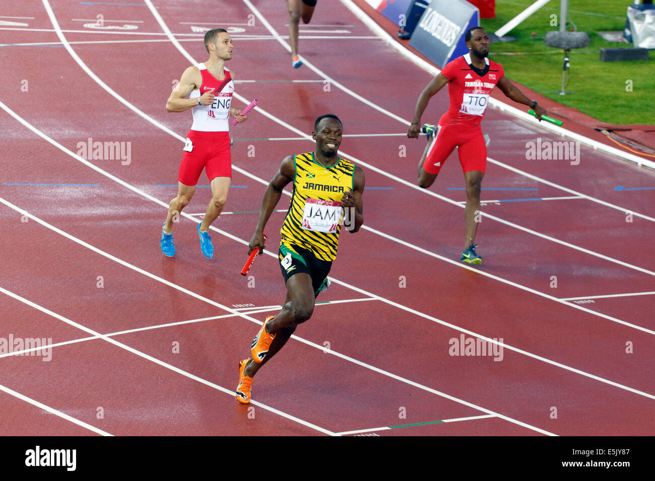 Hampden Park, Glasgow, Scotland, UK, Saturday, 2nd August, 2014. Glasgow 2014 Commonwealth Games, Men's 4 x 100m Relay Final. After the finish line. Left to Right. England Silver Danny Talbot, Jamaica Gold Usain Bolt, Trinidad and Tobago Bronze Richard Thompson Stock Photo