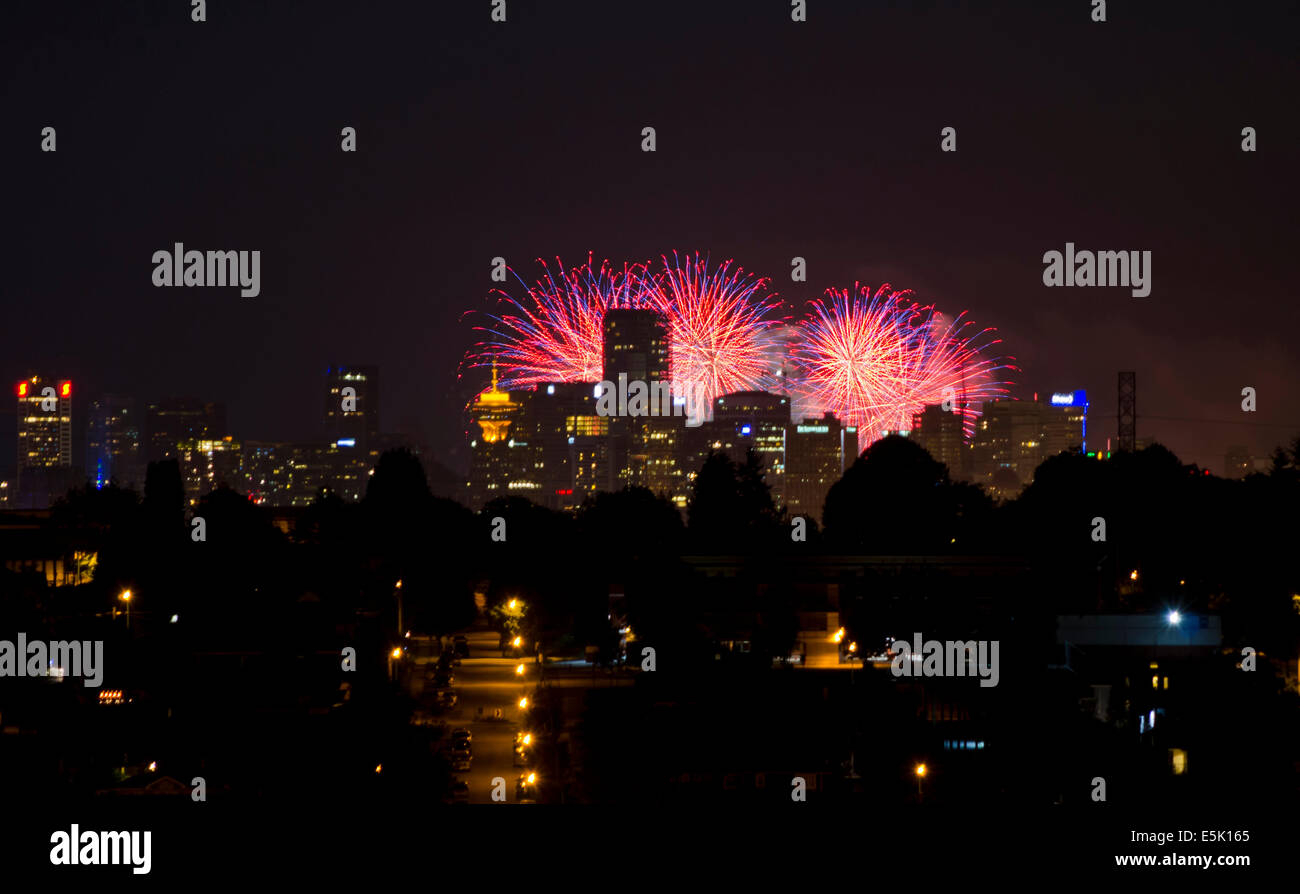 VANCOUVER, BC, CANADA. AUGUST 2, 2014: Downtown Vancouver is illuminated by the fireworks sent off from English Bay during the Honda Celebration of Light fireworks competition.  It was Japan's turn to present their entry into the annual competition which attracted thousands of spectators Credit: Maria Janicki/Alamy Live News. Stock Photo