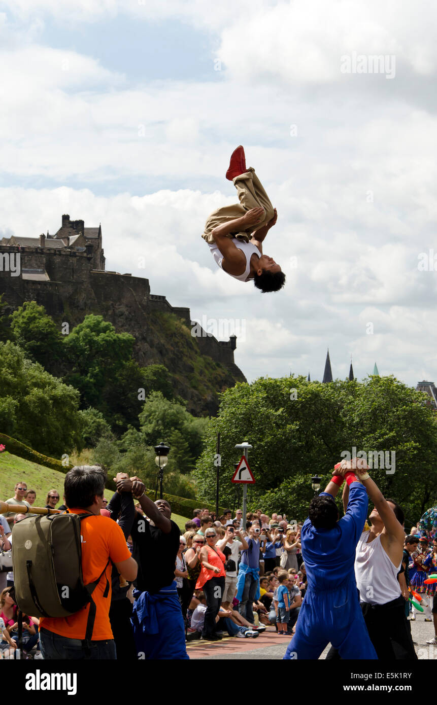 Acrobat being thrown through the air in the parade at the start of the ...