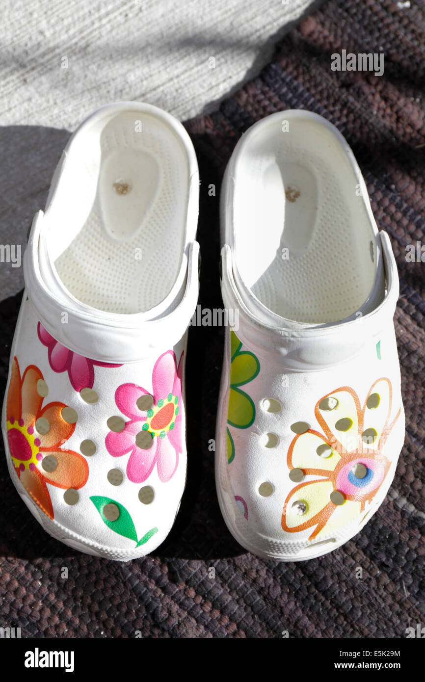 Plastic shoes with flowers Stock Photo - Alamy