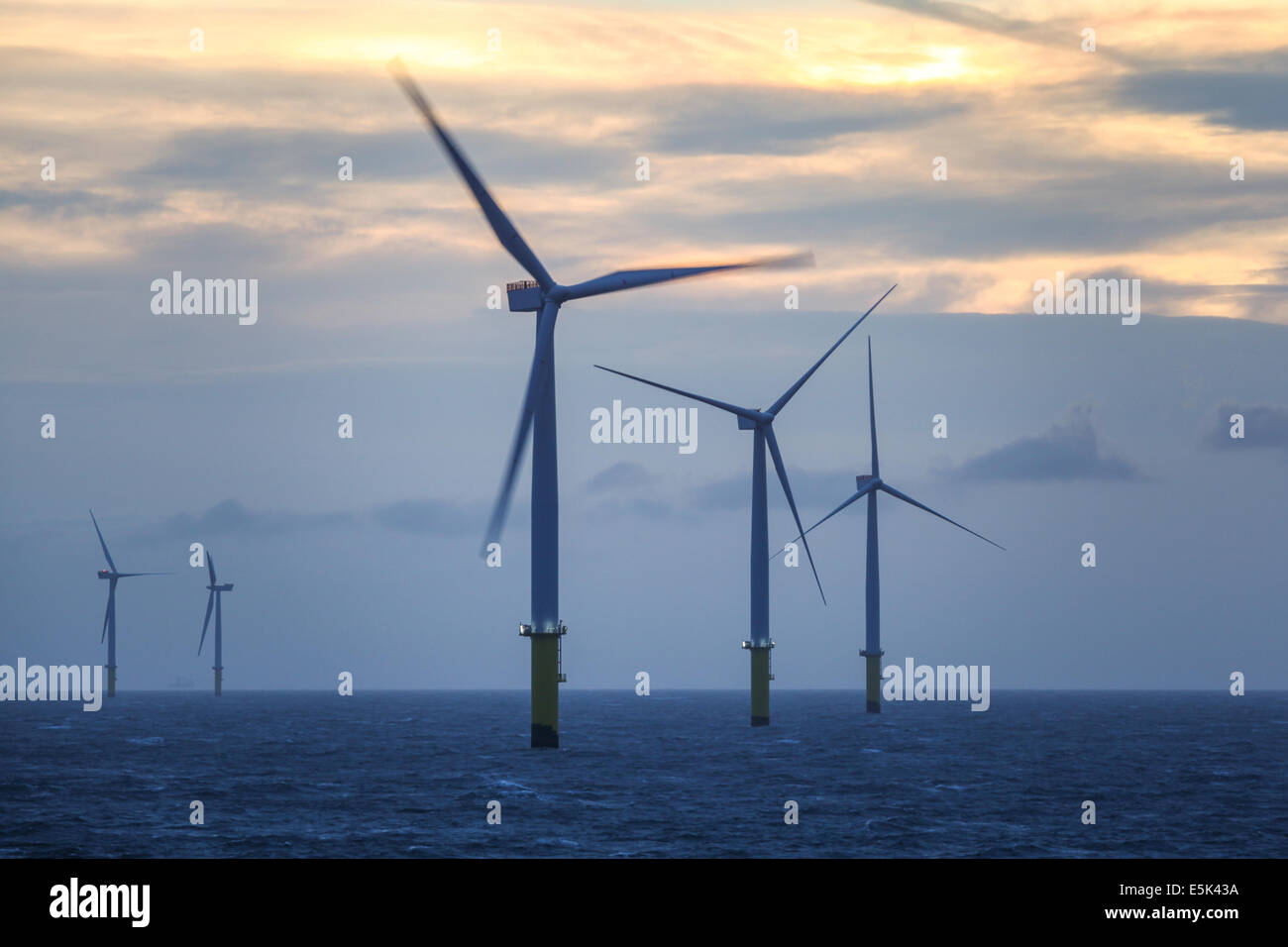 Dawn on the Gwynt y Mor Offshore Wind Farm off the coast of North Wales during the construction phase of spring 2014 Stock Photo