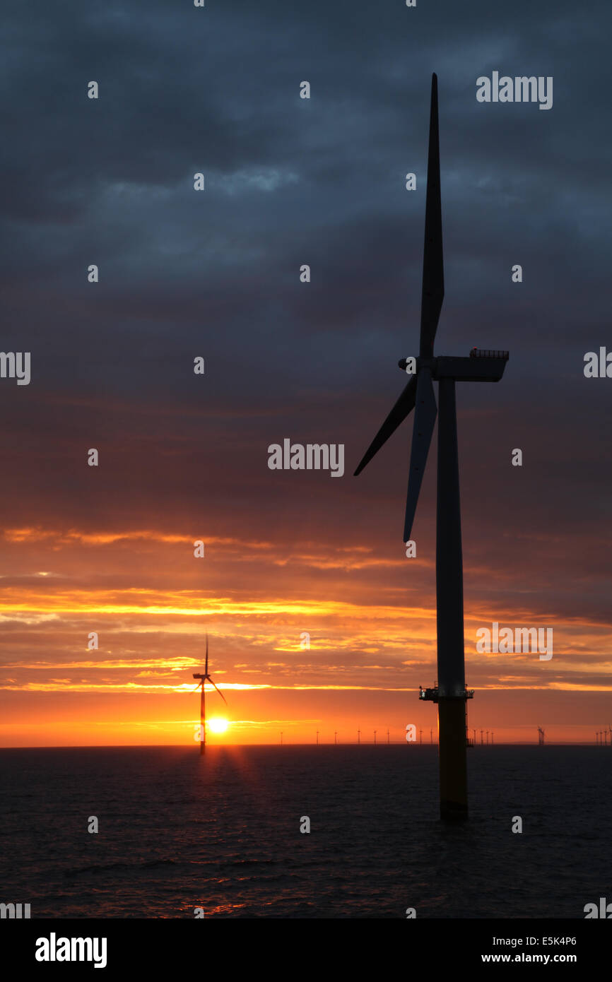 Sunrise on the Gwynt y Mor Offshore Wind Farm off the coast of North Wales during the construction phase of spring 2014 Stock Photo