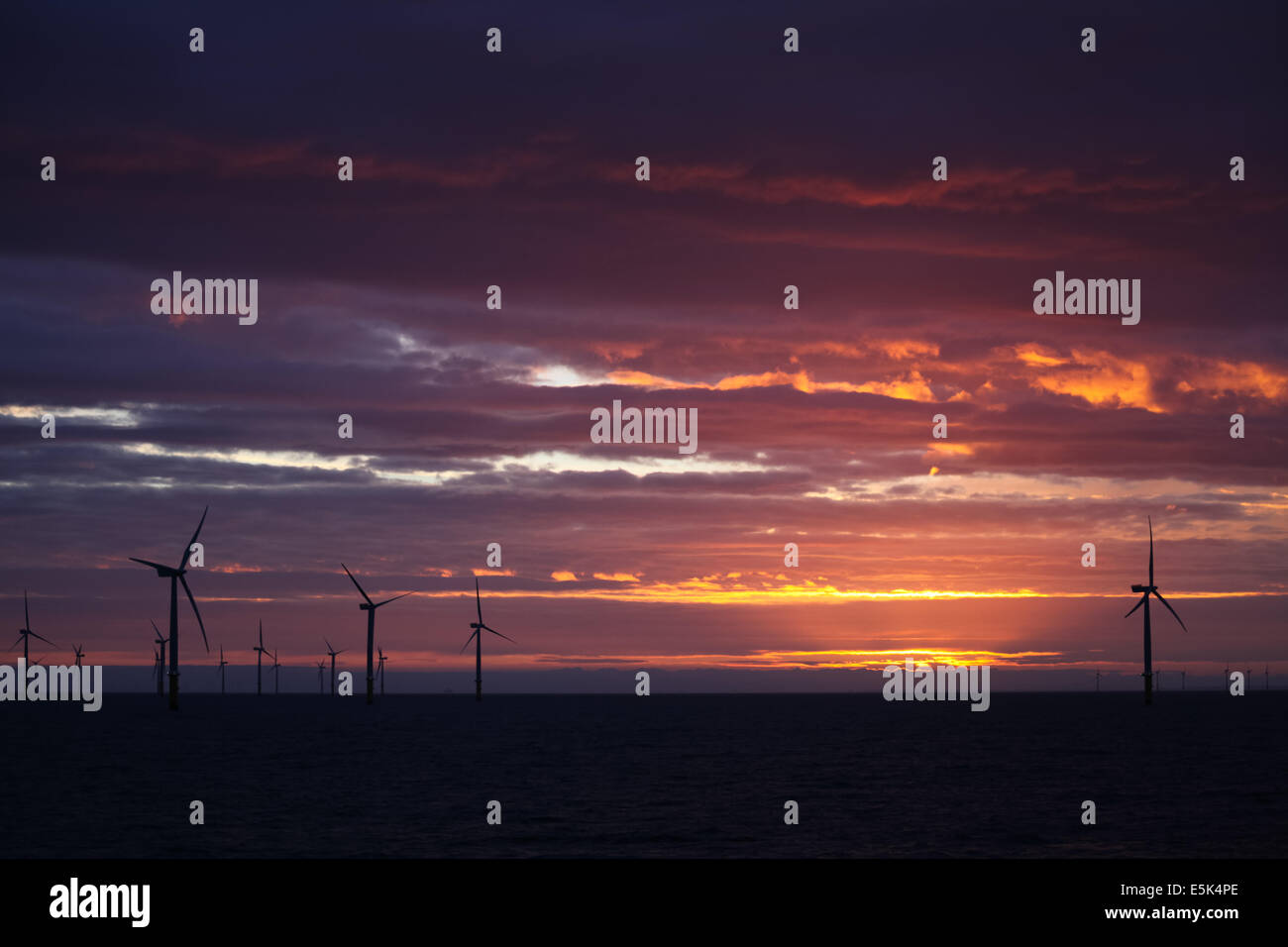Sunrise on the Gwynt y Mor Offshore Wind Farm off the coast of North Wales during the construction phase of spring 2014 Stock Photo