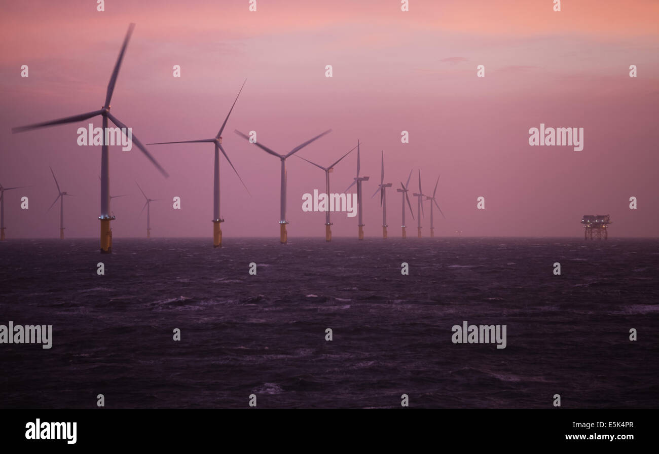 Dawn on the Gwynt y Mor Offshore Wind Farm off the coast of North Wales during the construction phase of spring 2014 Stock Photo