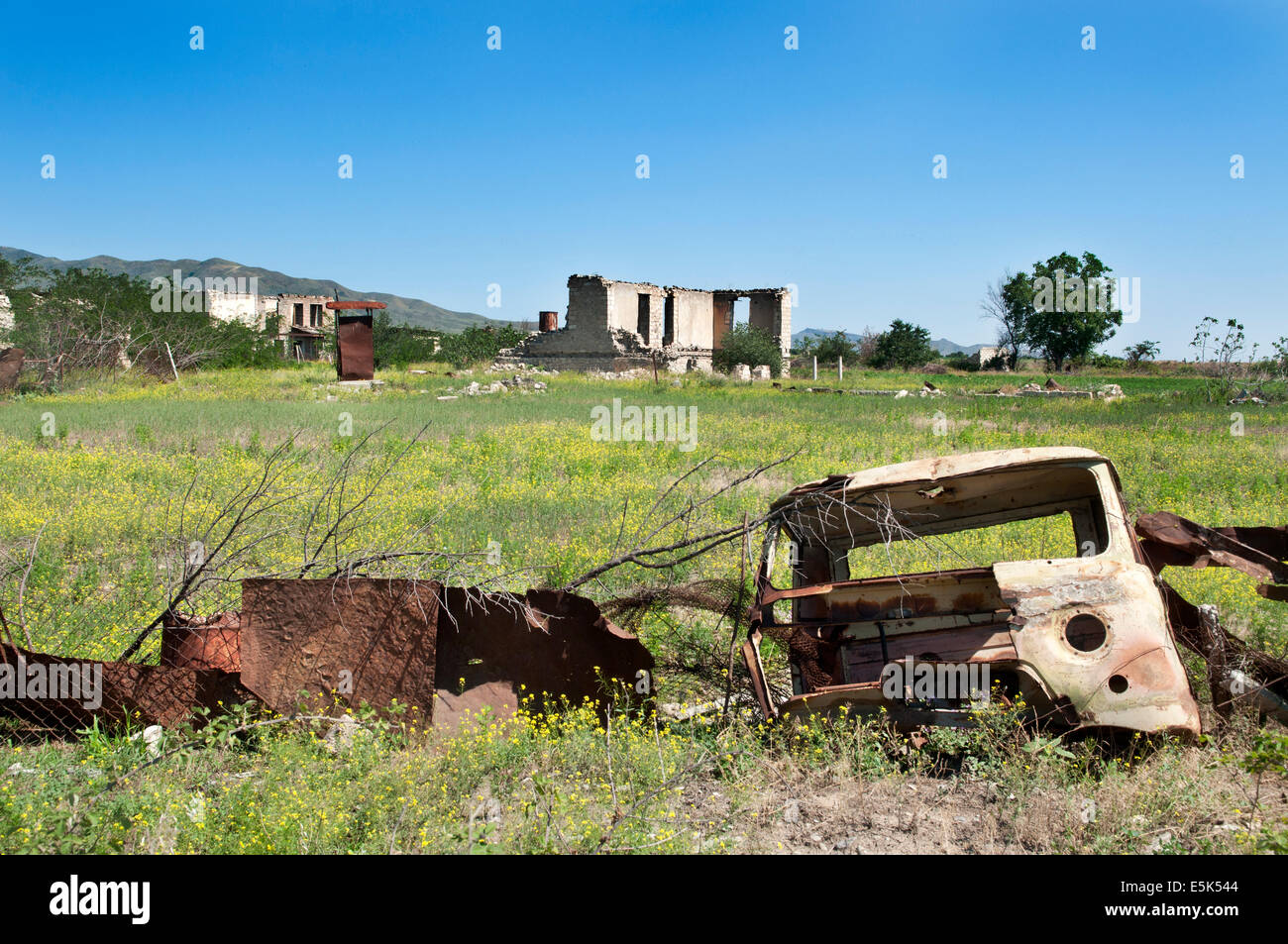 Destroyed truck used as a fence, Agdam ghost town, unrecognized state of Nagorno-Karabakh Stock Photo