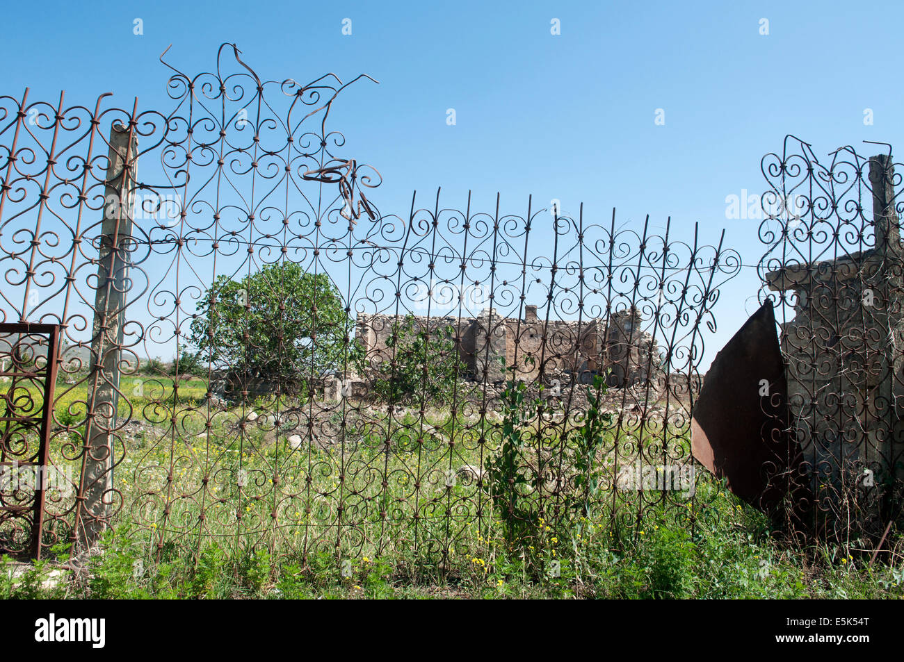 Destroyed house and fence, Agdam ghost town, unrecognized state of Nagorno-Karabakh Stock Photo